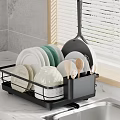 Black Kitchen Dish Rack With Plates Bowls Spoons Near Sink On Marble Countertop