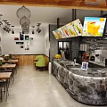 Bubble Tea Shop Interior Featuring Marble Counter Wooden Chairs Hanging Lights And Menu Screens
