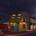 Illuminated Container Coffee Shop In Urban Area With Modern High Rise Buildings At Night