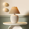 Stylish Table Lamp With White Textured Base And Beige Fabric Lampshade On White Round Tray