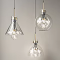 Three Modern Glass Pendant Lights With Transparent Shades And Visible Bulbs
