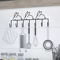 Wall Mounted Rabbit Shaped Hook Rack Holding Various Kitchen Utensils On White Wall 3d model