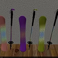Pink Purple Yellow Snowboards And Ski Poles Leaning Against Wall On Wooden Floor