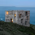 Seaside Detached Villa on Hillside with Concrete Exterior Square Windows and Illuminated Ocean View
