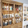 Wooden And White Decorative Cabinets Filled With Bottles Jars And Decor Items