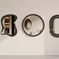 Modern Decorative Mirrors in Various Shapes with Black Frames Hanging on Beige Wall