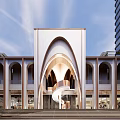Modern Building Exterior With Curved Arches Water Feature Sculpture In Open Plaza High Rise Background