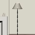 Modern Floor Lamp With Black Pole Cream Lampshade And Cylindrical Accents Near White Shelf