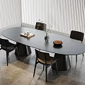 Modern Oval Black Dining Table Set With Four Chairs Vase And Plate On Gray Floor