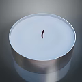 White Round Candle With Red Wick In Silver Container On Gray Background