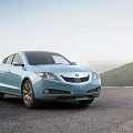 Light Blue Acura Sedan On Road With Mountain View