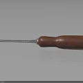 Screwdriver With Red Wooden Handle And Metal Shaft On Reflective Surface