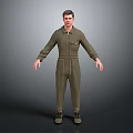 Man in Green Overalls Standing with Hands Naturally Hanging Down on Gray Background