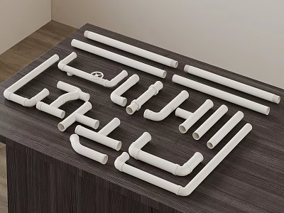 White Plumbing Pipes and Various Fittings Displayed on Dark Wooden Table 3d model