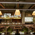 Rustic Mountain Hotpot Restaurant Interior With Stone Walls Green Plants Wooden Tables Pendant Lights