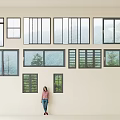 Various Types of Glass Windows Arranged on Wall with Person Standing