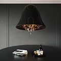 Black Chandelier With Gold Accents Crystal Details Above Black Table With Books Bottle Decor