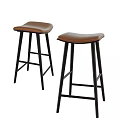 Two Modern Bar Stools With Brown Leather Seats And Black Metal Legs