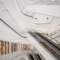 Modern Shopping Mall Lobby With Escalators Shiny Floor White Pillars And Information Signage
