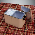 Portable Freezer With Open Lid And Perforated Inner Tray On Plaid Tablecloth