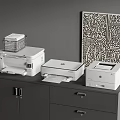White Modern Office Appliances Placed On Gray Cabinet With Abstract Artwork