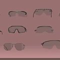 Various Styles of Safety Glasses and Goggles in Multiple Pairs on Pink Background