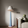 Blue Floor Lamp with White Lampshade Pink Edge and Green Dinosaur Toy on Beige Sofa
