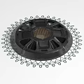 Black Circular Mechanical Component With Central Mesh Panel And Outer Gear Like Structure