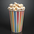 Freshly Popped Popcorn In Colorful Striped Paper Cup With White Kernels