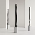 Modern Metal Sculptures On White Pedestals With Light Colored Walls And Floor