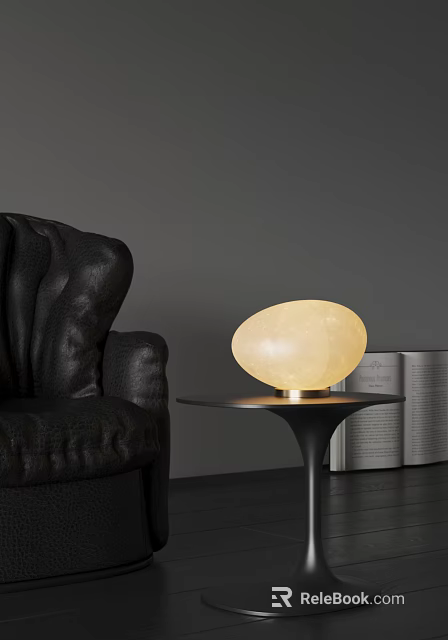 Oval Shaped Cream Colored Table Lamp with Gold Base on Black Table Near Leather Sofa 3d model 