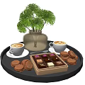 Latte Coffees With Latte Art Chocolate Box And Cookies On Black Tray With Green Plant