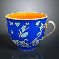 Blue Ceramic Cup With Orange Interior And Gold Handle Floral Patterns