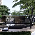 Modern Residential Landscape With High Rise Buildings Lush Green Trees And Pedestrian Walkways