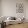 White Curved Multi Seater Sofa With Decorative Pillows Side Table Lamp And Abstract Wall Art