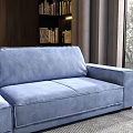 Blue Sectional Sofa with Plush Cushions and Throw Blanket in Modern Living Space