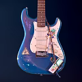 Blue Electric Guitar Instrument with Art Supplies and Sticker on Dark Background