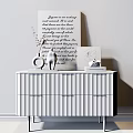 White Console Table with Vase Red Flowers Statue Photo Frame Books Against Light Wall