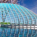 Modern Pergola With Blue And White Striped Curved Structure Wooden Platform And Greenery