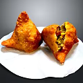 Crispy Fried Triangular Samosa With Vegetable Filling On White Plate