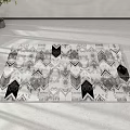 Black and White Square Rug with Geometric Pattern in Modern Living Room with White Walls and Potted Plant