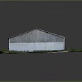 Long Industrial Building With Metal Roof Surrounded By Green Grass
