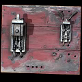 Vintage Switch Panel on Red Worn Wooden Board with Rusted Mechanisms and Holes