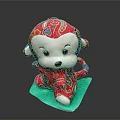 Red Monkey Plush Toy With Colorful Pattern And White Face On Green Mat