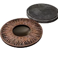 Copper Colored Circular Lid With Engraved Fortress Islands Patterns And Black Cover