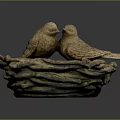 Two Bird Sculptures Perched On Woven Bird Nest Against Dark Background