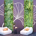 Leisure Sofa Set with White Sofas Orange Cushions and Green Plant Wall Background