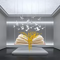 Interior Open Book Art Installation Featuring Yellow Decorations And Hanging White Birds