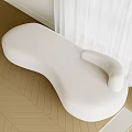 White Irregular Shaped Sofa In Modern Minimalist Room With Natural Light