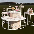 Outdoor Dessert Shop Display With White Tables Sweet Treats And Flower Bouquets